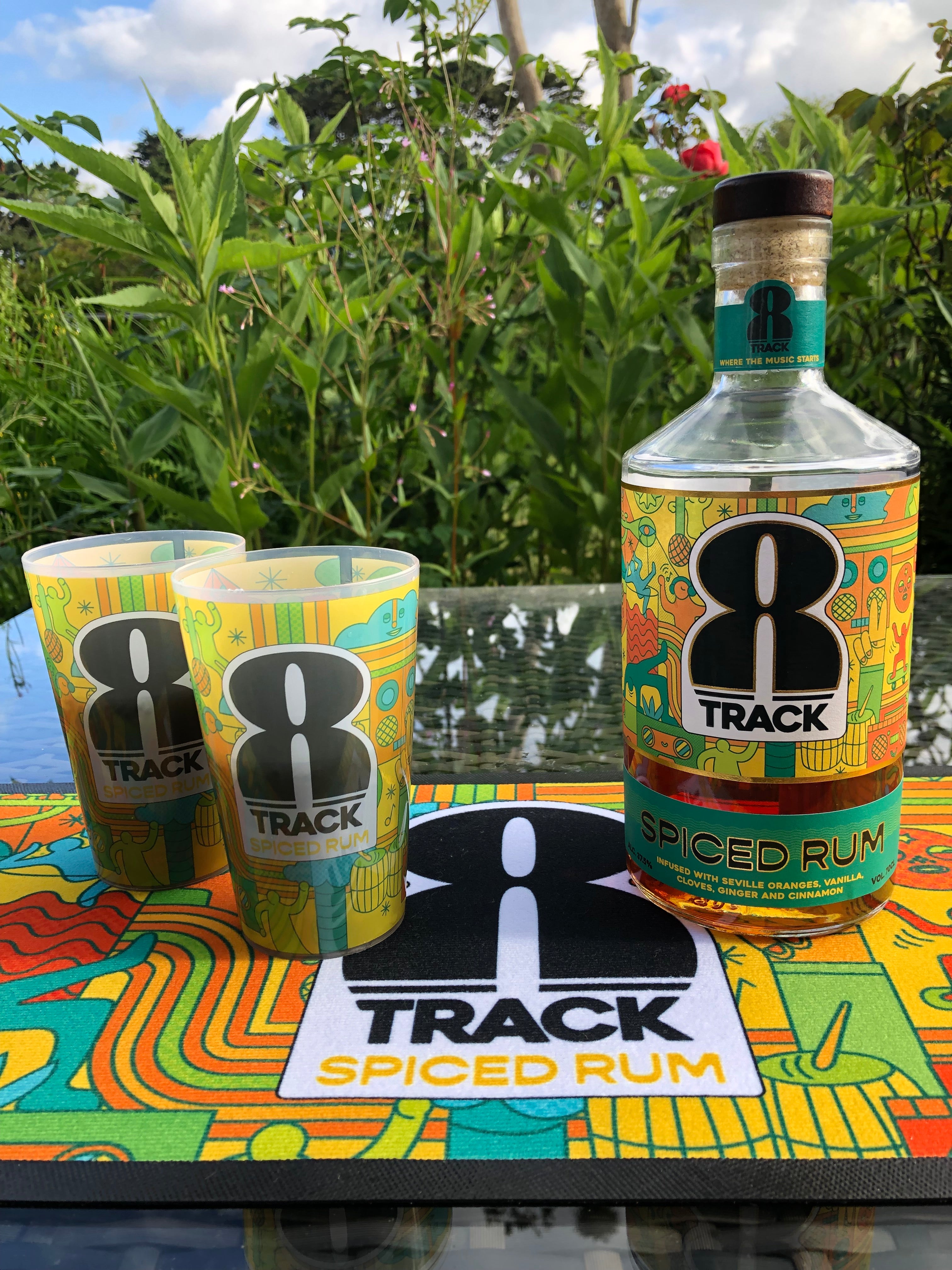 Bottle of 8Track Rum on a table with two branded 8Track Rum festival cups